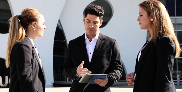 Young Business Partners Using Tablet alt