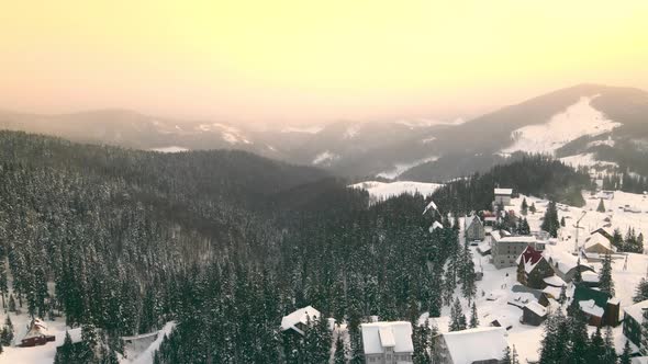 Amazing Aerial Flight Over Colorful Sunrise in the Mountains in Winter alt