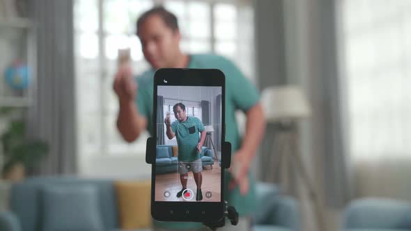 Man Shoots Video Content For Social Networks And Shows Focus On The Smartphone, Magician With Cards alt