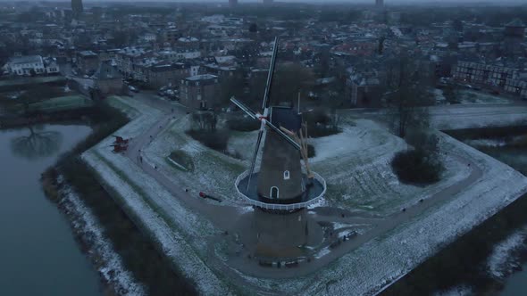 Mill At Bank Of Linge River With Town Buildings Of Gorinchem In Background During Winter In South Ho alt