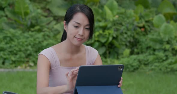 Woman Use of Digital Tablet with Green Background