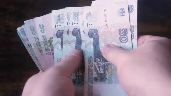 Bunch of Russian rubles are counted in the male hand