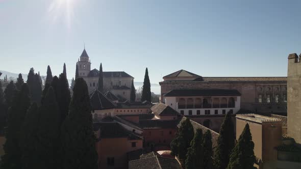 Aerial backward over roof of Alhambra citadel, Granada in Spain. Sky for copy space
