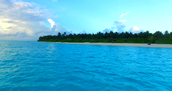 Wide fly over travel shot of a sunshine white sandy paradise beach and turquoise sea background in c alt