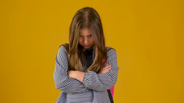 portrait of a schoolgirl with a briefcase is offended and angry
