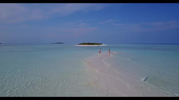 Boy and girl in love on luxury resort beach time by blue sea with white sandy background of the Mald alt