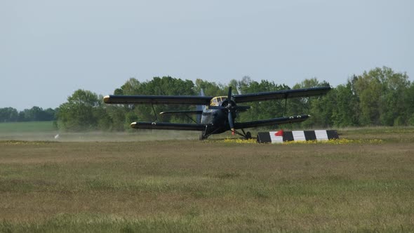 Small Old Propeller Plane is Moving Towards the Runway in Field After Landing alt