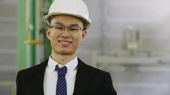 Joyful senior executive going through factory