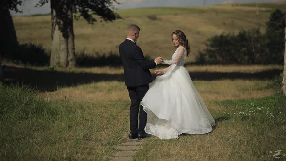 Caucasian Groom with Bride in the Park. Wedding Couple. Happy Family. Newlyweds alt