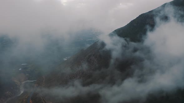 Aerial view inside clouds in Canyon del Colca in the Andes Mountains in Peru 4K