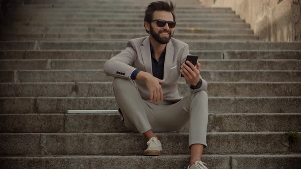 Businessman With Phone On Step. Freelancer Internet Online Meeting Webinar. Man Freelance. alt