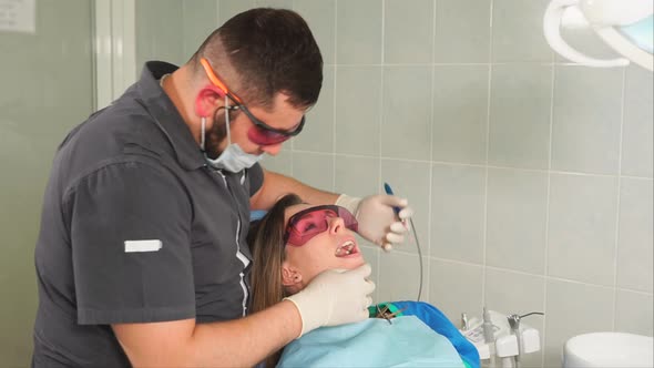 Professional Dentist Making Dental Treatment to Female Patient alt