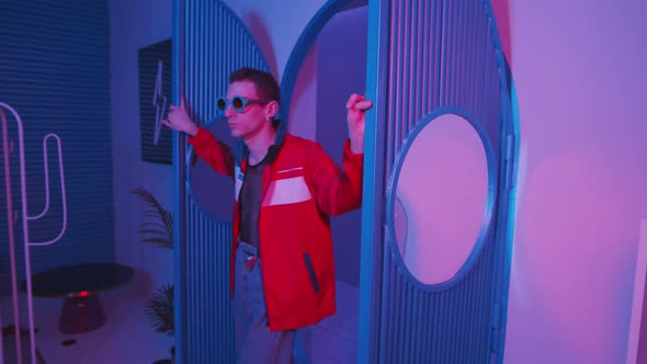 Trendy Man Walking into Nightclub with Color Lighting alt