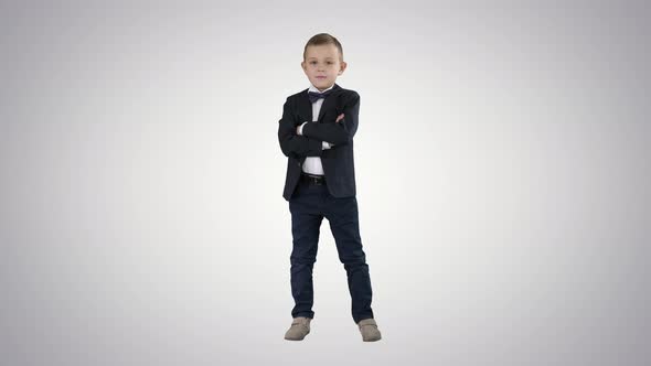 Handsome Child Looking at Camera and Crossing Hands on Gradient Background alt