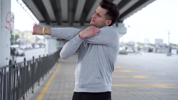 Fit man warming up outdoor in slow motion, Close up fitness man training stretch exercise outdoor alt