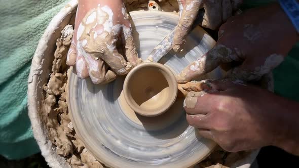 Top View on Potter's Hands Work with Clay on a Potter's Wheel alt