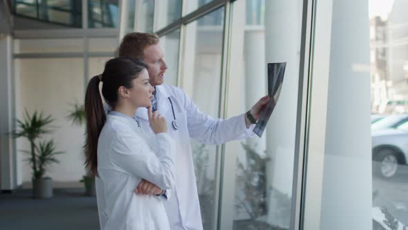 Team of doctors examining x-ray image in the office