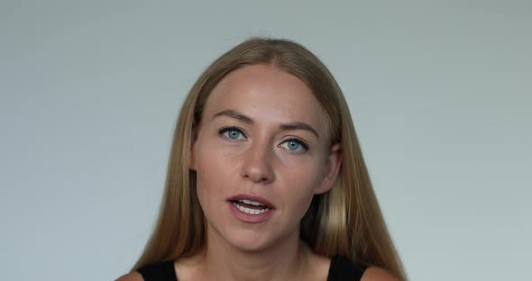 Portrait of Adorable Young Blonde European Woman Smiling Talking Looking at Camera Medium Shot