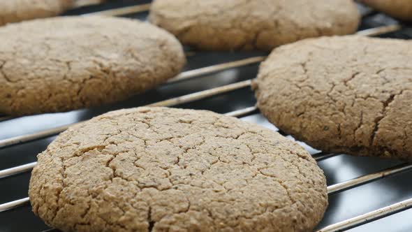 Buckwheat bread product on baking oven rack 4K 2160p 30fps UltraHD tilting footage - Close-up of hom alt