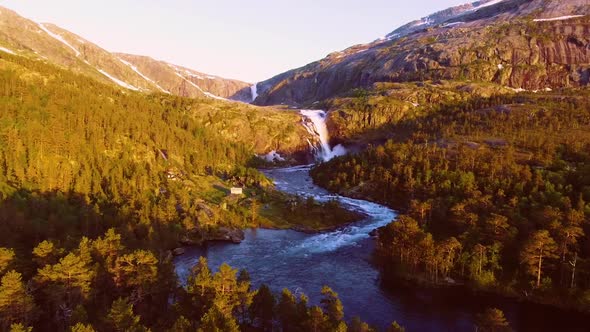 Aerial View of Rapid Stunning Waterfall in Husedalen Valley, Norway. Summer Time.