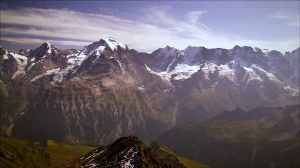 Panning shot of mountain peaks in Switzerland alt