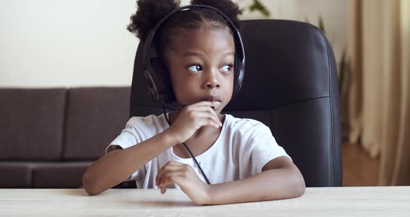 View From Webcam Little Cute Girl Child African American Kid Wears Headphones Speaks Into Microphone alt