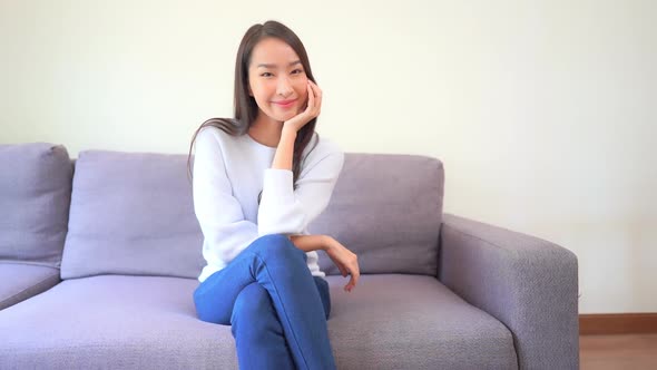Asian woman sit on sofa and relax alt