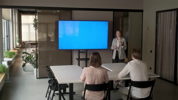 Diverse office conference room meeting: female project manager uses Chroma Key wall mounted alt