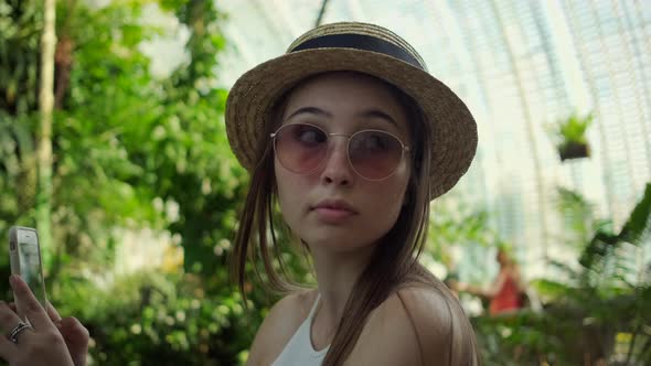 Asian Tourist Woman is Taking Photo in Botanical Garden of Lednice Castle alt