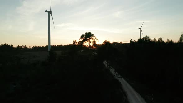 Two Giant Wind Turbines On A Valley At Sunset In Serra de Aire And Candeeiros - Leiria, Portugal