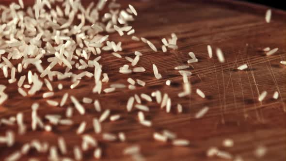 Uncooked Rice is Scattered on the Table and Rotated alt