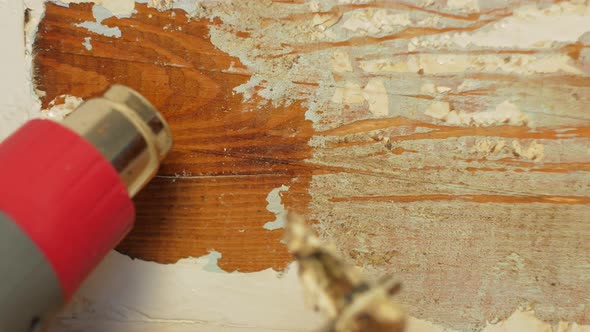 Easy cheap restoration of wooden door window. Restorer carpenter peels off paint from painted timber