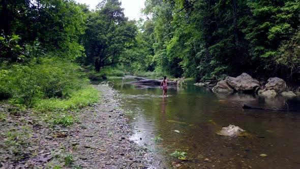 Young Woman in Bikini Walking in the River Thailand alt