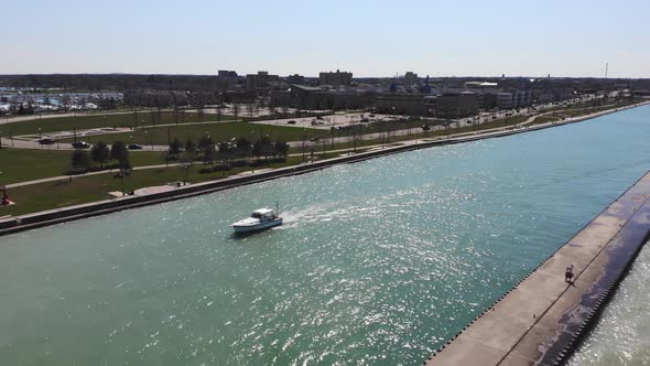 Aerial View White Boat Moving Down a Canal in Lake Michigan in Illinois alt