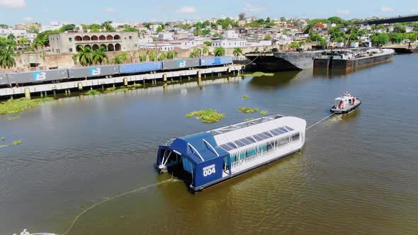 View of interceptor 004 collecting garbage in the Ozama River, Santo Domingo alt