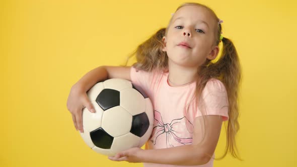 Authentic Cute Smiling Preschool Little Girl with Classic Black and White Soccer Ball Look at Camera alt