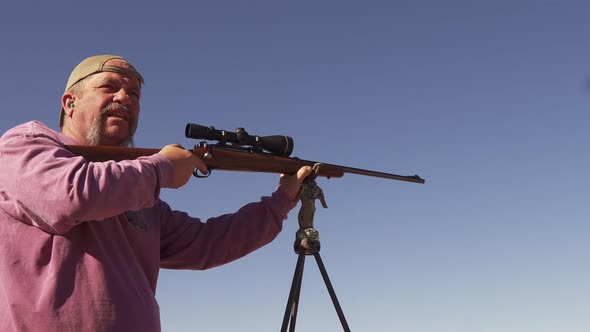 A man uses a bolt action rifle for target practice before deer hunting on the Colorado range.  A spe alt