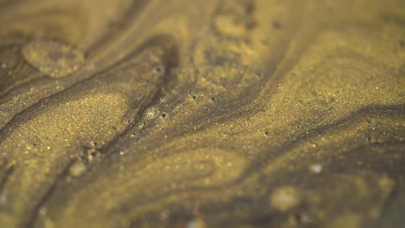 Macro Rotation Of Gold Paint Particles