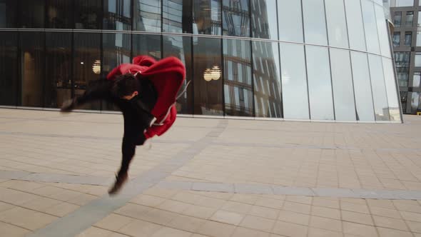 Sportsman Practicing Parkour Side Flip Outdoors alt