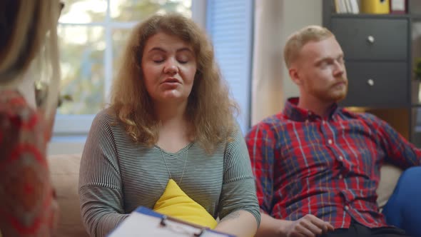 Irritated Couple Discussing Their Problems at Marital Therapy with Psychologist alt