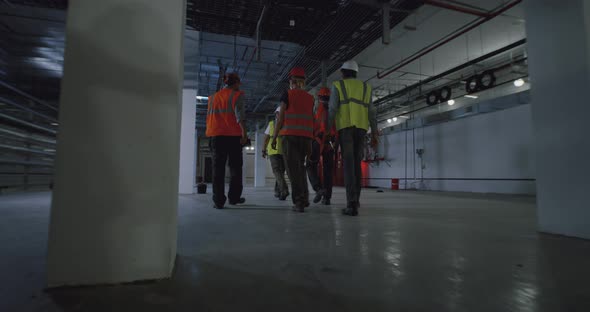 Anonymous Employees Working in Spacious Workshop alt