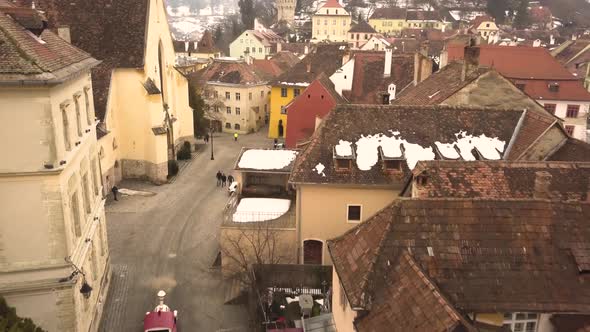 A dolly movement drone shot, amidst a vintage architechtural lane in a closed locality, capturing a alt