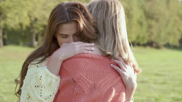 Two girlfriends hugging.