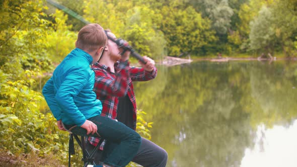 Fishing on Nature - Big Brother Teaching His Little Brother Fishing - Throws the Fishing Rod alt
