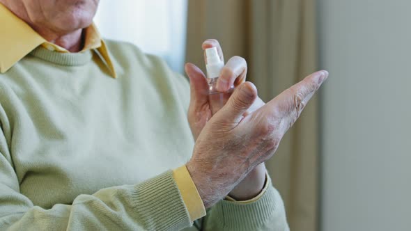 Closeup Hands Elderly Man Unrecognizable Pensioner Cleaning Arms By Sanitizer Antiseptic Spray alt