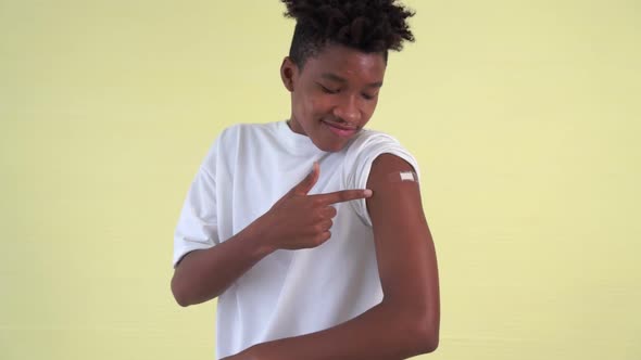 African American Teenager Showing COVID19 Vaccine Bandage Merrily alt
