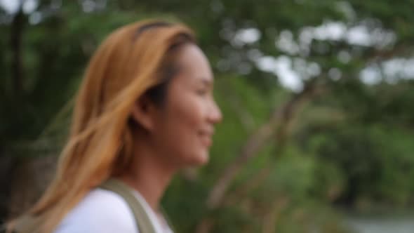 Portrait of woman traveler smiling in the nature alt