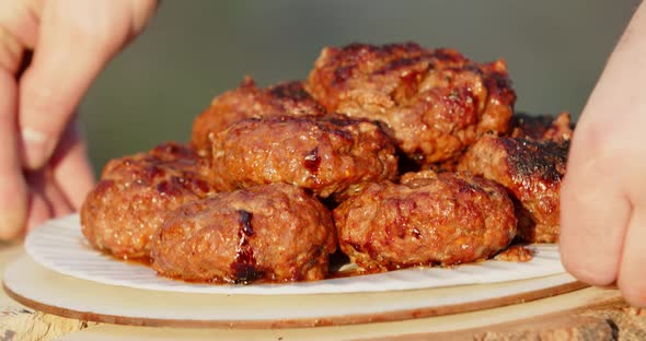 Cutlets Are Laid Out On A Plate And Placed On A Stump. Grilled Meatballs