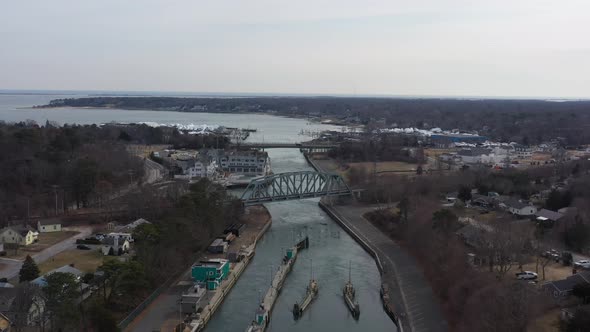 An aerial view over the Shinnecock Canal in Hampton Bays, Long Island, NY. The drone camera dolly in alt