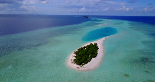 Beautiful birds eye abstract view of a white sandy paradise beach and turquoise sea background in 4K alt